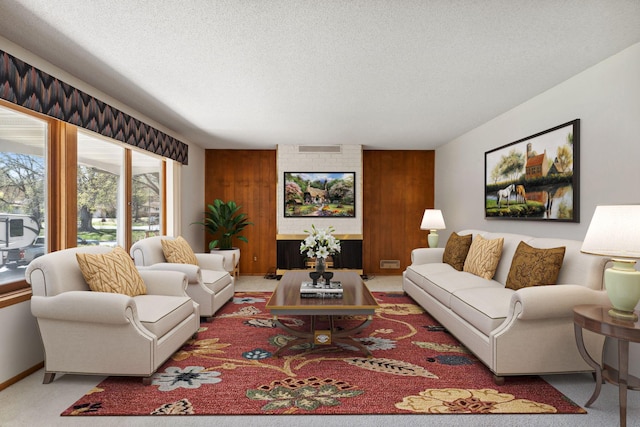 living room featuring a textured ceiling, carpet floors, and wooden walls
