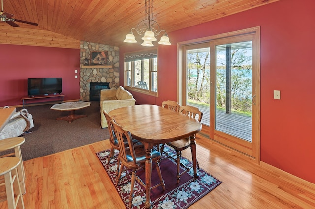 10209 Amery Ave NW, Silver Creek Twp, MN 55362 - dining room with wooden ceiling, a stone fireplace, wood finished floors, vaulted ceiling, and a ceiling fan