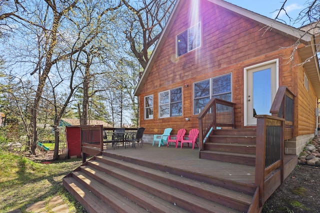 10209 Amery Ave NW, Silver Creek Twp, MN 55362 - rear view of house featuring outdoor dining area and a wooden deck