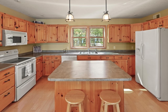 10209 Amery Ave NW, Silver Creek Twp, MN 55362 - kitchen featuring white appliances, light wood-type flooring, a sink, and a kitchen island