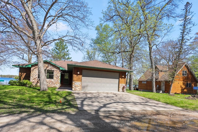 10209 Amery Ave NW, Silver Creek Twp, MN 55362 - view of front of house with concrete driveway, an attached garage, a front yard, and stone siding