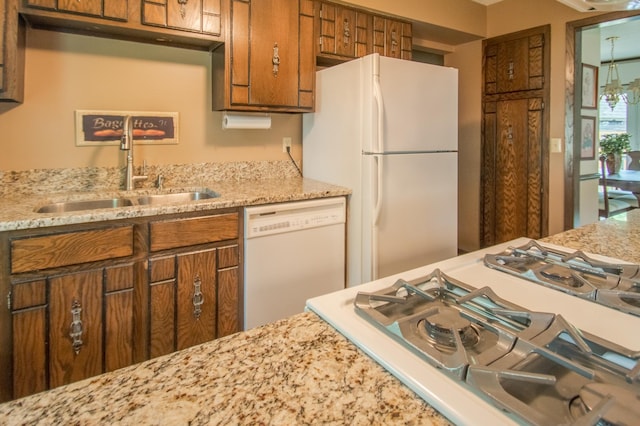 10929 108th Ave N, Maple Grove, MN 55369 - kitchen featuring white appliances, brown cabinets, and light stone countertops