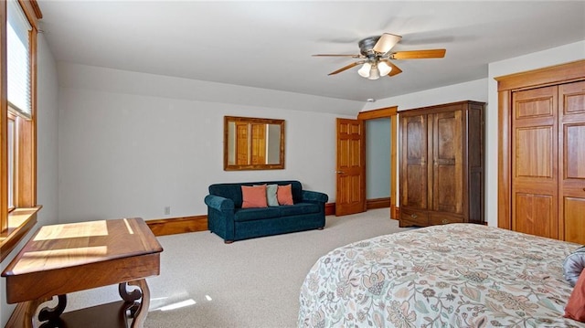 bedroom with a ceiling fan, baseboards, and light colored carpet