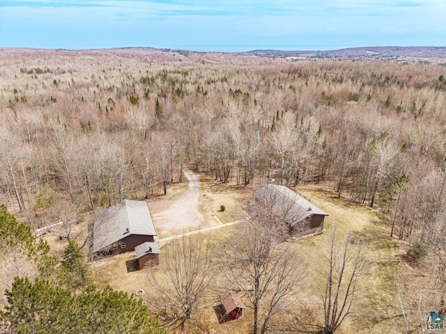 drone / aerial view featuring a wooded view