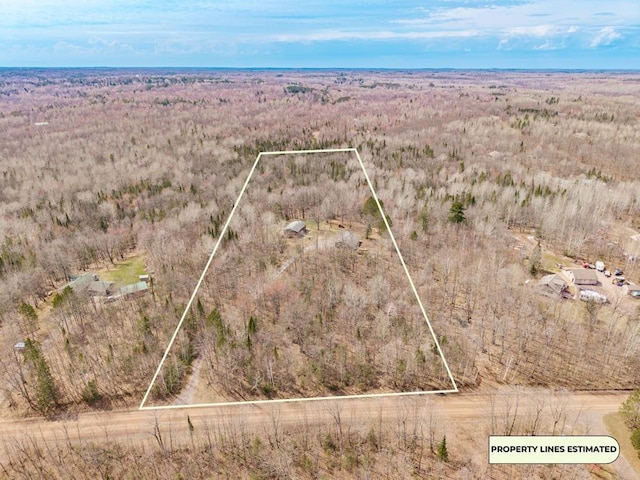 birds eye view of property with a wooded view