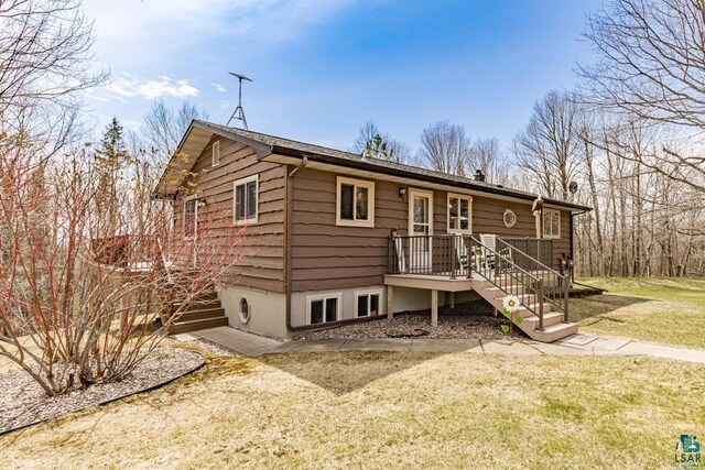 rear view of property with a lawn