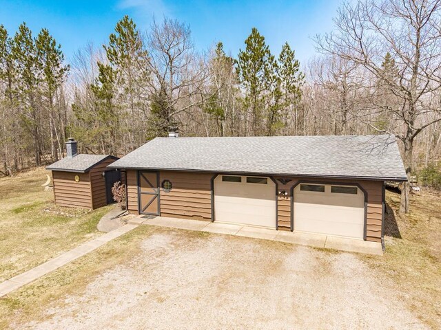 detached garage with dirt driveway