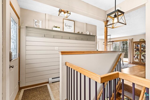 interior space with baseboards, a notable chandelier, and a baseboard radiator