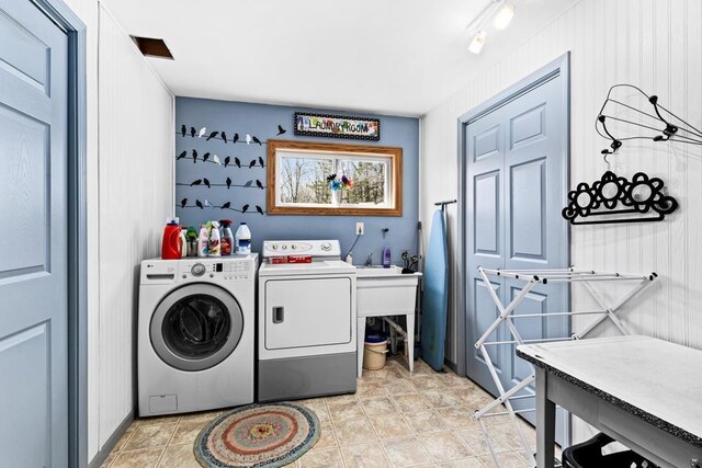 clothes washing area with laundry area and washer and clothes dryer