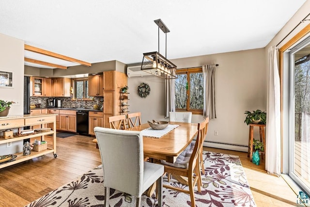dining area with an AC wall unit, light wood-style flooring, a chandelier, and baseboard heating