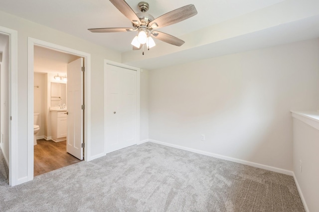 601 Harry Davis Ln, Minneapolis, MN 55411 - unfurnished bedroom with carpet floors, baseboards, ensuite bath, a ceiling fan, and a closet