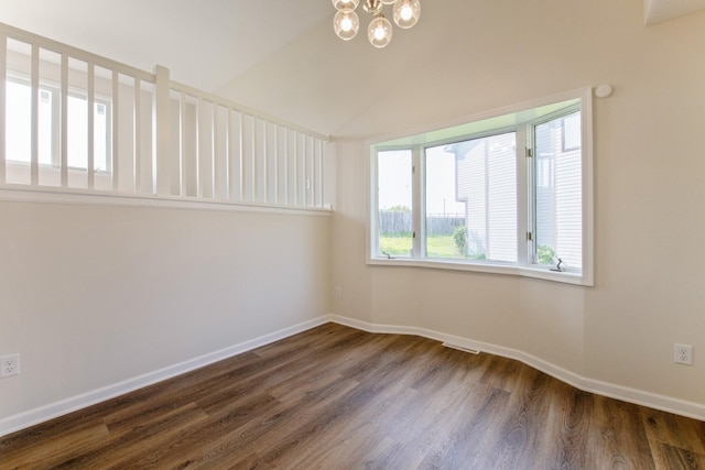 601 Harry Davis Ln, Minneapolis, MN 55411 - empty room with dark wood-style flooring, baseboards, a chandelier, and vaulted ceiling