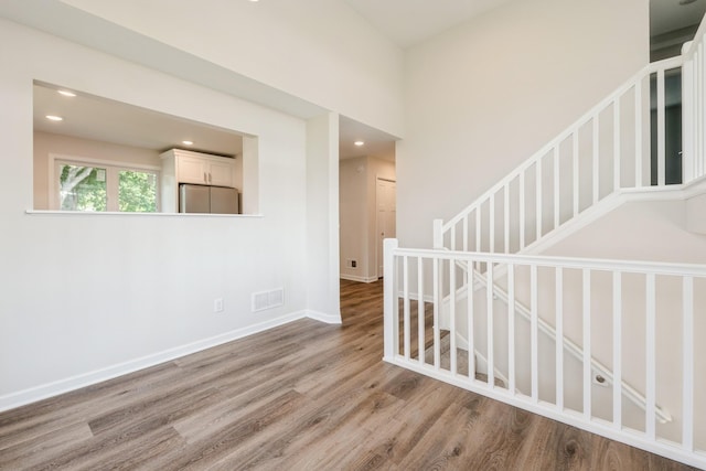 601 Harry Davis Ln, Minneapolis, MN 55411 - spare room featuring wood finished floors, baseboards, and recessed lighting
