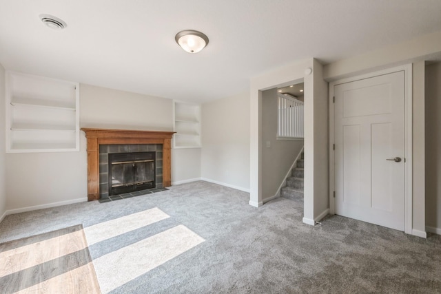 601 Harry Davis Ln, Minneapolis, MN 55411 - unfurnished living room featuring carpet, stairs, baseboards, and a tiled fireplace