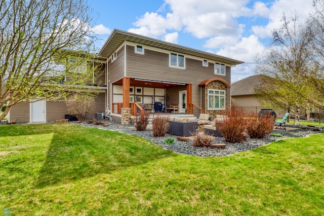 back of property with a yard, a patio, an outdoor living space, and central air condition unit