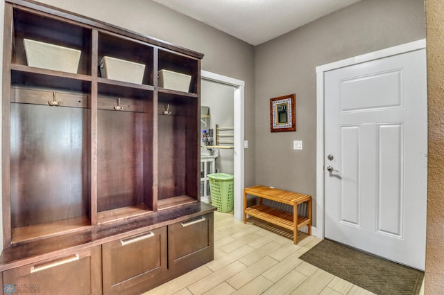 mudroom with wood finish floors