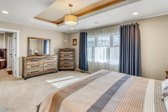 bedroom with light colored carpet, a raised ceiling, and recessed lighting