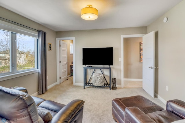 living room featuring light carpet and baseboards