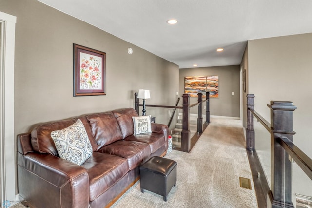 living room featuring carpet floors, baseboards, visible vents, and recessed lighting