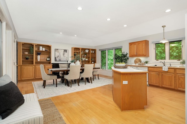 2117 Indian Rd W, Minnetonka, MN 55305 - kitchen with white dishwasher, a center island, light wood-type flooring, light countertops, and recessed lighting