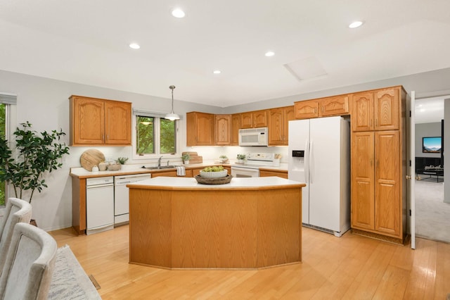 2117 Indian Rd W, Minnetonka, MN 55305 - kitchen featuring white appliances, a sink, a kitchen island, plenty of natural light, and recessed lighting