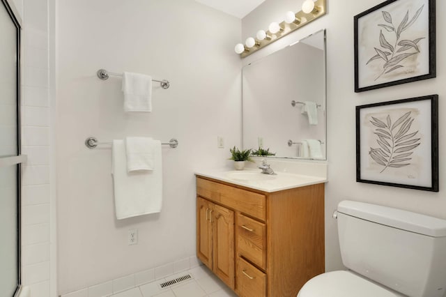 2117 Indian Rd W, Minnetonka, MN 55305 - bathroom with toilet, vanity, an enclosed shower, and tile patterned floors