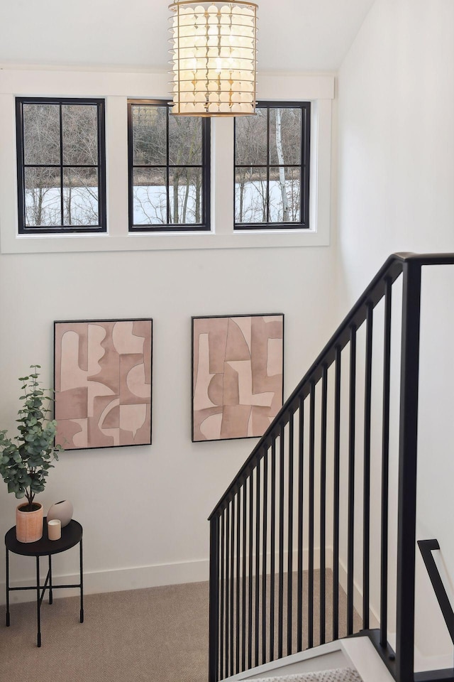 stairway with carpet floors and baseboards