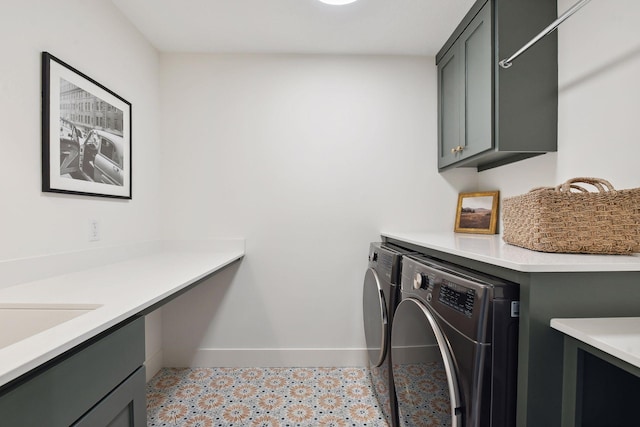 laundry room with cabinet space, washing machine and dryer, and baseboards