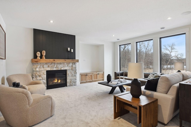 living room featuring light colored carpet, a fireplace, and recessed lighting