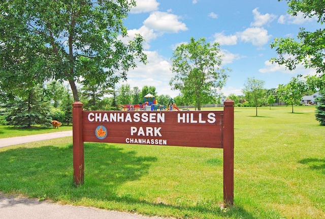community / neighborhood sign with a yard