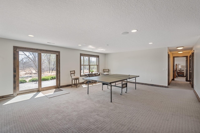 rec room featuring recessed lighting, baseboards, and light carpet