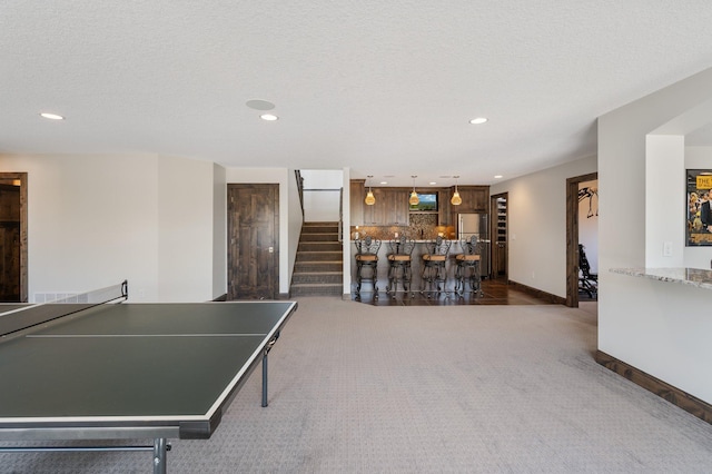 playroom with recessed lighting, baseboards, a dry bar, and dark carpet