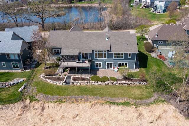 birds eye view of property featuring a water view and a residential view