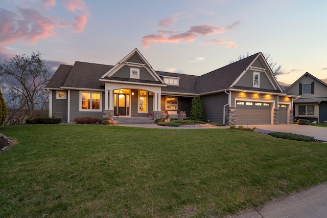 craftsman-style home featuring a porch, a lawn, a garage, concrete driveway, and stone siding