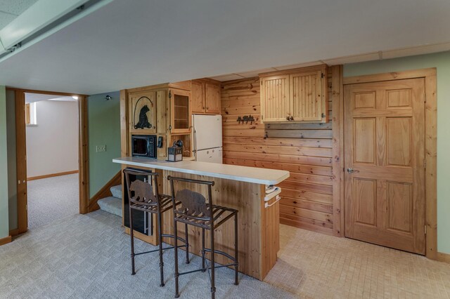 2064 View Dr NW, Walker, MN 56484 - kitchen featuring freestanding refrigerator, a peninsula, a breakfast bar, light countertops, and baseboards