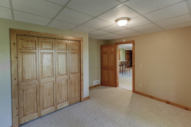 2064 View Dr NW, Walker, MN 56484 - unfurnished bedroom with a paneled ceiling, light colored carpet, and baseboards