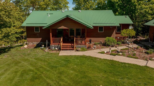 2064 View Dr NW, Walker, MN 56484 - view of front of home featuring a front yard, log veneer siding, metal roof, and a wooden deck