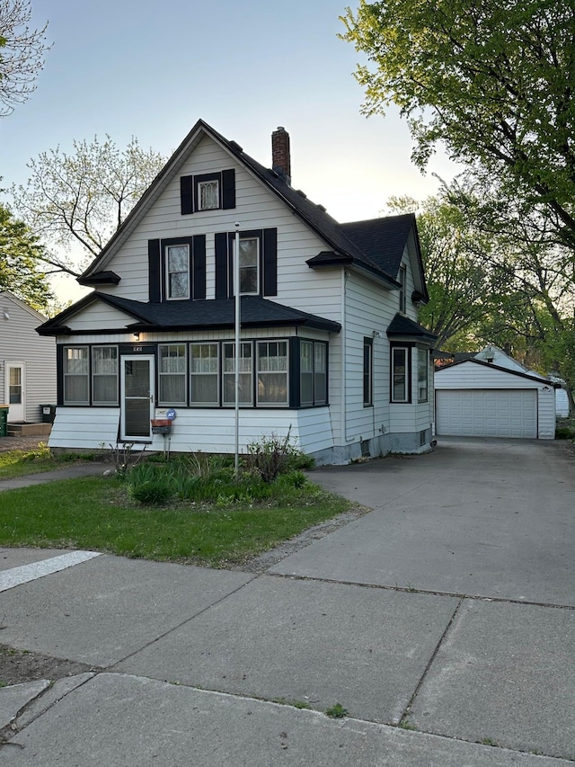 958 Allen Ave W, Saint Paul, MN 55118 - traditional-style house with a chimney, an outdoor structure, a detached garage, a sunroom, and roof with shingles