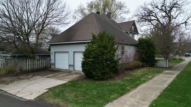 view of side of home with fence, a chimney, a shingled roof, and a garage