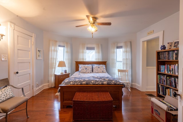 bedroom featuring baseboards, a ceiling fan, and wood finished floors