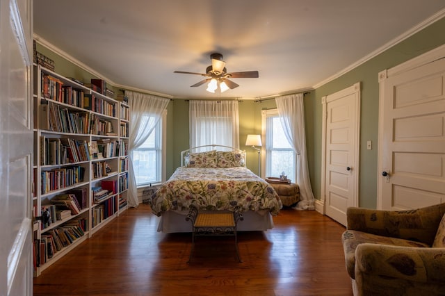 bedroom with ceiling fan, ornamental molding, wood finished floors, and multiple windows