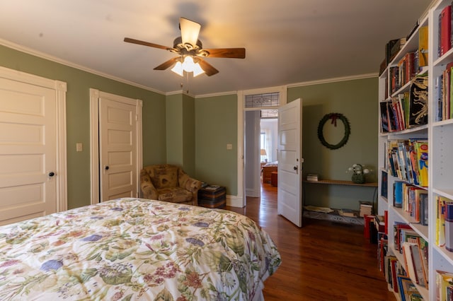 bedroom with dark wood-style flooring, baseboards, ornamental molding, and a ceiling fan