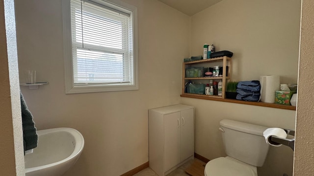 bathroom featuring toilet and a sink