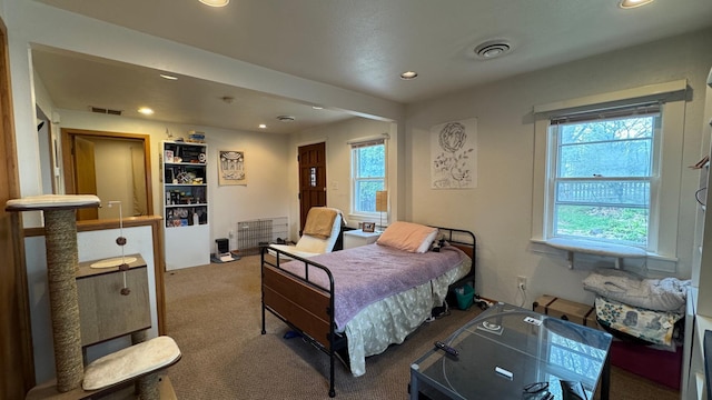 bedroom with visible vents, recessed lighting, carpet, and multiple windows