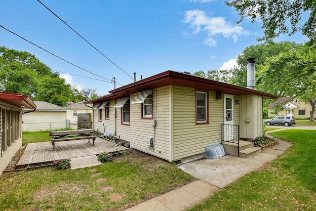 6001 Bryant Ave N, Brooklyn Center, MN 55430 - rear view of property with a wooden deck and a yard