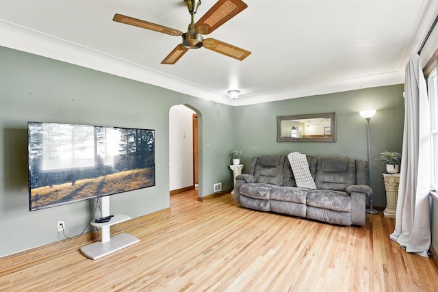 6001 Bryant Ave N, Brooklyn Center, MN 55430 - living area featuring arched walkways, wood finished floors, ceiling fan, and baseboards