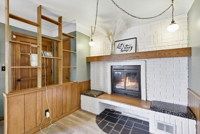 6001 Bryant Ave N, Brooklyn Center, MN 55430 - detailed view of a brick fireplace, a wainscoted wall, wood finished floors, and wood walls