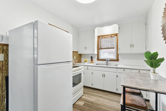 6001 Bryant Ave N, Brooklyn Center, MN 55430 - kitchen with white appliances, a sink, light countertops, white cabinetry, and light wood-type flooring