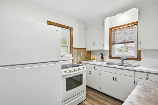 6001 Bryant Ave N, Brooklyn Center, MN 55430 - kitchen with white appliances, a sink, light countertops, light wood-style floors, and white cabinets