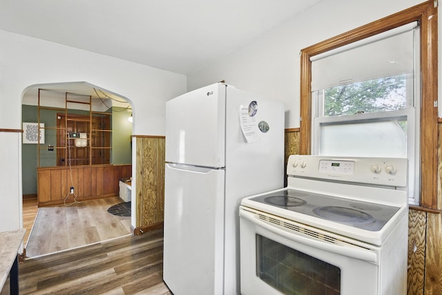 6001 Bryant Ave N, Brooklyn Center, MN 55430 - kitchen with white appliances, wood finished floors, and arched walkways